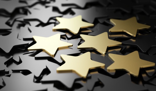 gold stars on a pile of black stars award concept